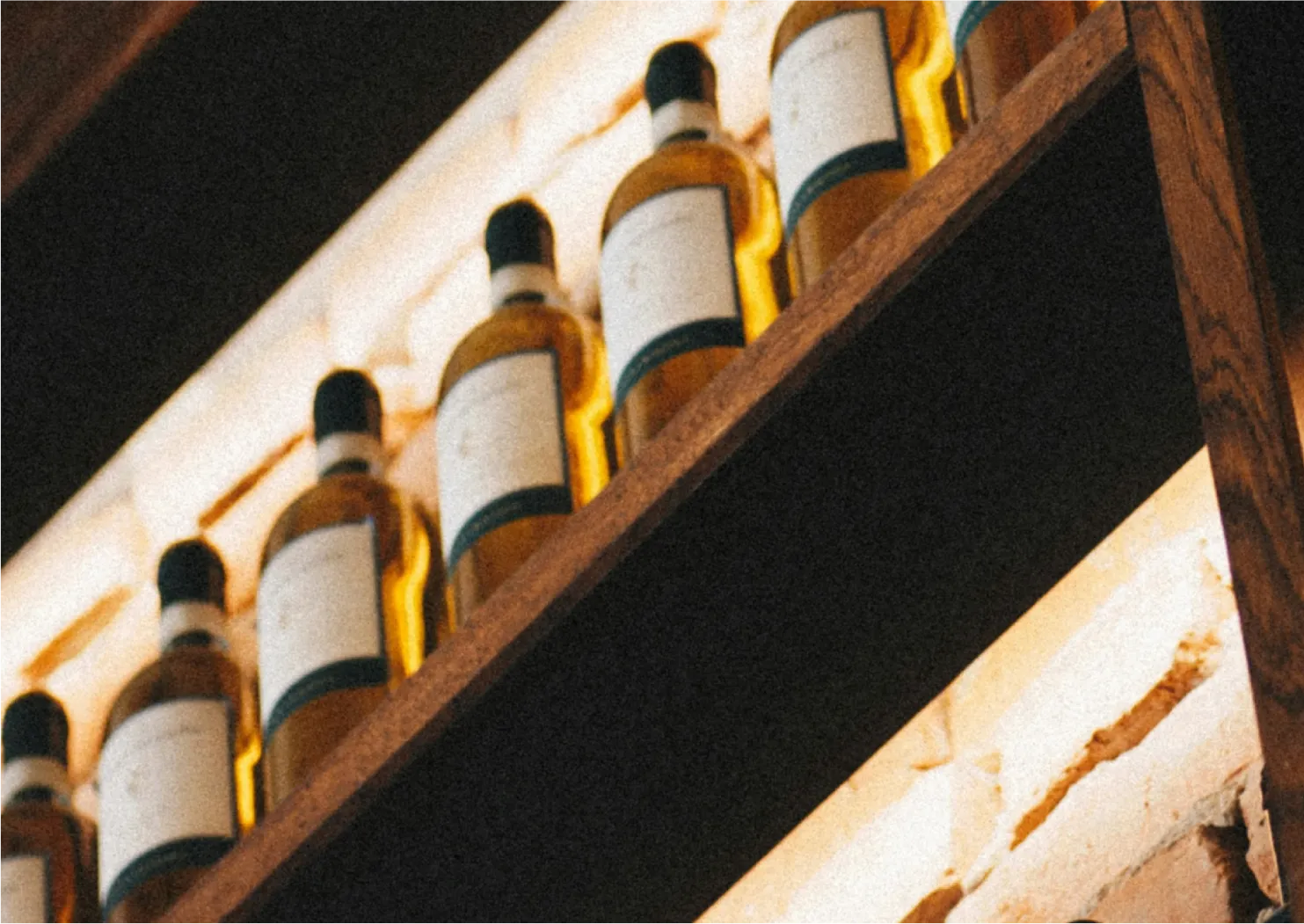 Collector consulting a bottle in their cellar